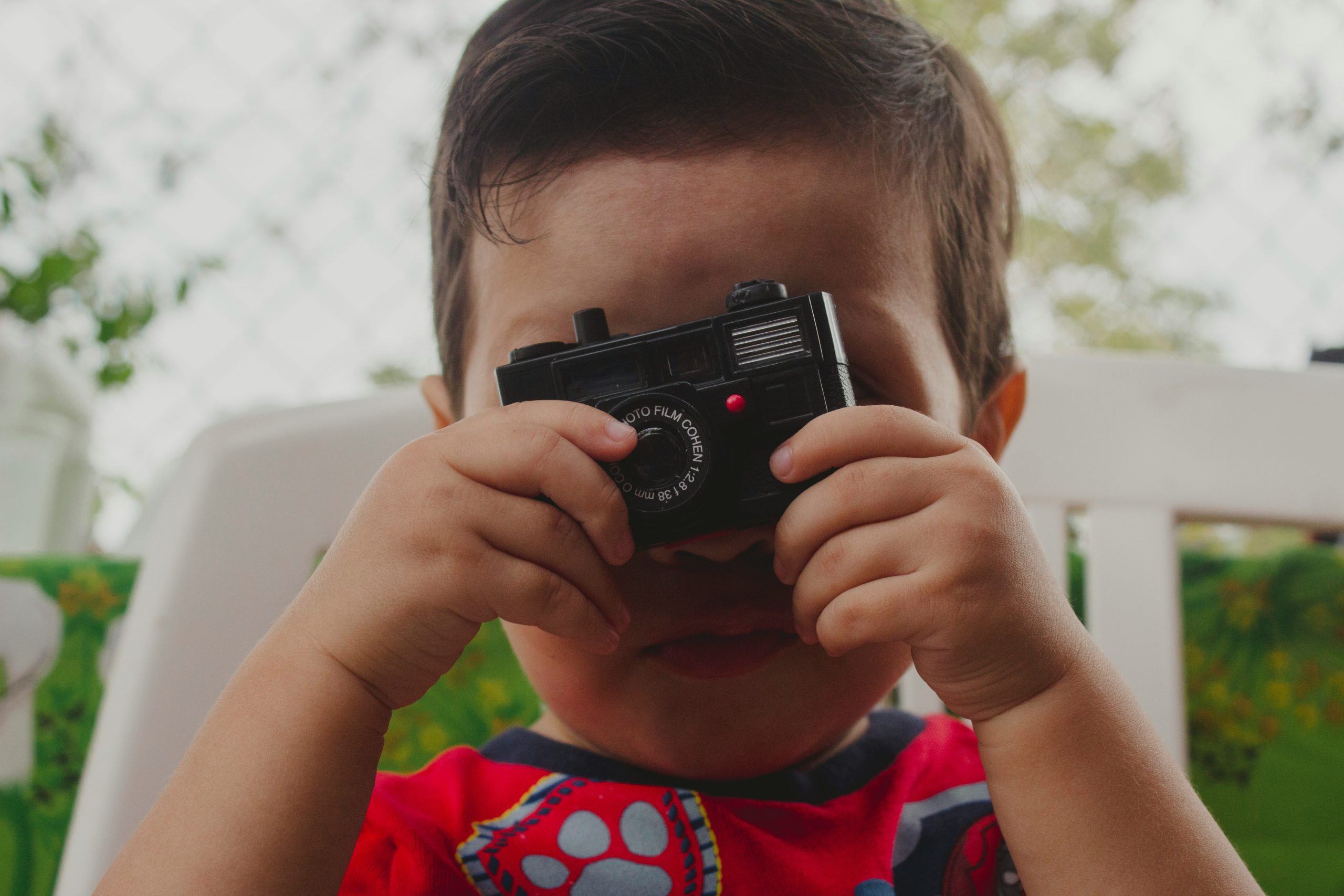 kid playing with camera